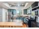 Updated kitchen featuring stainless steel appliances, countertops, and custom cabinets offering ample storage at 10806 W Evans Ave # 5, Lakewood, CO 80227