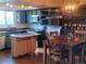 Bright, open kitchen with stainless appliances, a moveable kitchen island, and an adjacent dining area at 10806 W Evans Ave # 5, Lakewood, CO 80227