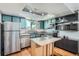 Charming kitchen with modern appliances, ample cabinetry and kitchen island at 10806 W Evans Ave # 5, Lakewood, CO 80227