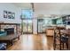 Open-concept living room with wood floors, fireplace, and stainless steel appliances at 10806 W Evans Ave # 5, Lakewood, CO 80227