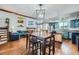 Open concept space with living, dining, and kitchen areas featuring wood floors and exposed beams at 10806 W Evans Ave # 5, Lakewood, CO 80227