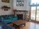 Comfortable living room featuring a stone fireplace and sliding door access to outside at 10806 W Evans Ave # 5, Lakewood, CO 80227