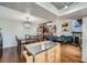 Open-concept living and dining area with hardwood floors, staircase and fireplace creates a warm and inviting atmosphere at 10806 W Evans Ave # 5, Lakewood, CO 80227