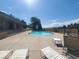 A community pool with a view of the mountains and lounge chairs at 10806 W Evans Ave # 5, Lakewood, CO 80227