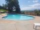 A community pool with a view of the mountains and lounge chairs at 10806 W Evans Ave # 5, Lakewood, CO 80227