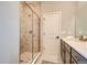Beautiful bathroom featuring a glass-enclosed shower, modern vanity, and elegant tile work at 95 N Vandriver Pl, Aurora, CO 80018