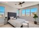 Spacious bedroom featuring plush carpet, stylish furniture, and abundant natural light from large windows at 95 N Vandriver Pl, Aurora, CO 80018