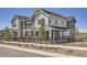 Charming townhome featuring stone accents, fenced yard, and modern architectural details at 95 N Vandriver Pl, Aurora, CO 80018