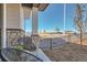 Cozy front porch with seating area overlooking a professionally landscaped front yard at 95 N Vandriver Pl, Aurora, CO 80018