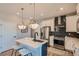 Bright kitchen featuring stainless steel appliances, large island, and eye catching backsplash at 95 N Vandriver Pl, Aurora, CO 80018