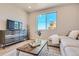 Cozy living room featuring modern decor, soft natural light, and stylish furnishings at 95 N Vandriver Pl, Aurora, CO 80018