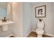 Modern powder room featuring sleek fixtures, stylish decor, and a clean design at 95 N Vandriver Pl, Aurora, CO 80018