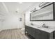 Spacious bathroom features a double vanity with a marble countertop, sleek fixtures and a large mirror at 4873 Cathay Ct, Denver, CO 80249