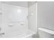 Clean bathroom features a shower and tub combo, white tile and neutral paint at 4873 Cathay Ct, Denver, CO 80249