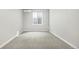 The gray carpet and walls make this bedroom a blank canvas, complete with natural light, and a mini split system at 4873 Cathay Ct, Denver, CO 80249