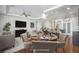 Staged dining area in living room features open floor plan and access to the kitchen at 4873 Cathay Ct, Denver, CO 80249