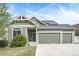 Charming home featuring an attached two car garage, solar panels, and a well-manicured lawn at 4873 Cathay Ct, Denver, CO 80249