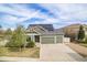 Charming home featuring an attached two car garage, solar panels, and a well-manicured lawn at 4873 Cathay Ct, Denver, CO 80249