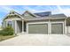 Charming home featuring an attached two car garage, solar panels, and a well-manicured lawn at 4873 Cathay Ct, Denver, CO 80249