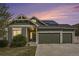 Charming two-story home featuring a three-car garage and well-manicured lawn at sunset at 4873 Cathay Ct, Denver, CO 80249