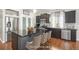 Modern kitchen features stainless steel appliances, dark cabinetry, and a kitchen island with seating at 4873 Cathay Ct, Denver, CO 80249