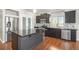 Modern kitchen features stainless steel appliances, dark cabinetry, and a kitchen island at 4873 Cathay Ct, Denver, CO 80249