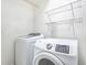 Laundry room featuring white washer and dryer units and wire rack shelving at 4873 Cathay Ct, Denver, CO 80249
