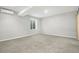 Unfurnished room features an energy-efficient mini-split, a large window, and plush carpeting at 4873 Cathay Ct, Denver, CO 80249