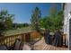 Outdoor deck with a grill and seating area overlooking the backyard at 7506 Chipmunk Pl, Littleton, CO 80125