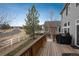 Back deck with fence overlooking the landscaped backyard and a BBQ grill at 7506 Chipmunk Pl, Littleton, CO 80125