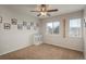 Bedroom features carpet, ceiling fan, and two windows with mountain view in the background at 7506 Chipmunk Pl, Littleton, CO 80125