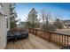 A well-maintained wooden deck with a grill and view of neighboring homes at 7506 Chipmunk Pl, Littleton, CO 80125