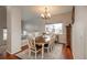 Dining room with hardwood floors, elegant chandelier, and a window with natural light at 7506 Chipmunk Pl, Littleton, CO 80125