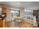 Cozy dining area with tile floors leads to the back deck and living area at 7506 Chipmunk Pl, Littleton, CO 80125