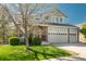 Well-maintained home with a three-car garage, landscaped front yard, and beautiful curb appeal at 7506 Chipmunk Pl, Littleton, CO 80125