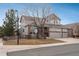 Well-maintained two-story home with a three-car garage and a beautifully landscaped front yard at 7506 Chipmunk Pl, Littleton, CO 80125