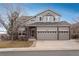 Charming two-story home with a three-car garage and a combination of siding and brick accents at 7506 Chipmunk Pl, Littleton, CO 80125