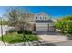 Beautiful two-story home with a three-car garage, lush lawn and mature shade tree at 7506 Chipmunk Pl, Littleton, CO 80125