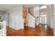 Open foyer with hardwood floors and staircase leading to the second floor, showcasing a bright entrance at 7506 Chipmunk Pl, Littleton, CO 80125