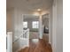 Upstairs hallway with hardwood flooring leading to carpeted bedrooms in a well-lit home at 7506 Chipmunk Pl, Littleton, CO 80125