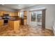 Spacious kitchen with tile flooring, stainless steel appliances, and access to the outdoor deck at 7506 Chipmunk Pl, Littleton, CO 80125