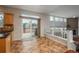 Bright living area with sliding glass doors opening to deck and view to sunken living room at 7506 Chipmunk Pl, Littleton, CO 80125