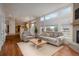 Open-concept living room boasts large windows, fireplace, and hardwood floors at 7506 Chipmunk Pl, Littleton, CO 80125