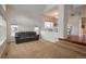 Bright living room with vaulted ceiling, carpet floors, and large windows for plenty of natural light at 7506 Chipmunk Pl, Littleton, CO 80125