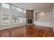 Spacious living room with hardwood floors, a cozy fireplace, and plenty of natural light at 7506 Chipmunk Pl, Littleton, CO 80125