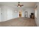 Large main bedroom featuring closet space, ceiling fan, and access to an en-suite bathroom at 7506 Chipmunk Pl, Littleton, CO 80125