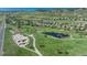 Aerial view of a park featuring a playground, skate park, tennis courts, pond, and walking trails at 7506 Chipmunk Pl, Littleton, CO 80125