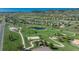 Wide aerial view of a park featuring green space, playground, tennis courts, and a pond at 7506 Chipmunk Pl, Littleton, CO 80125