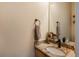 Elegant powder room with a decorative mirror, granite countertop, and stylish fixtures at 7506 Chipmunk Pl, Littleton, CO 80125