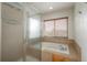 Modern shower and jetted tub with window for natural light at 7506 Chipmunk Pl, Littleton, CO 80125